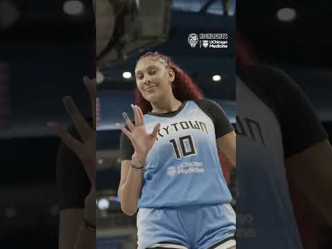 A usually shy Kamilla Cardoso waving to a sideline camera