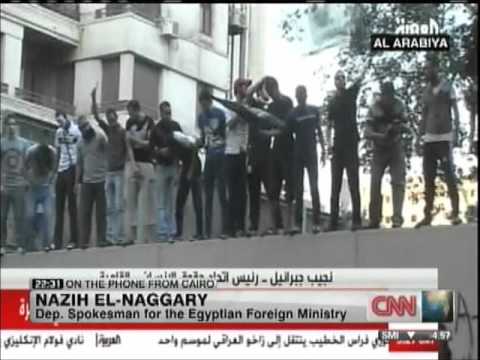 Click to Watch the Protestors Scale US Embassy in Egypt, Raise Islamist Flag. Consulate in Libya on Fire video