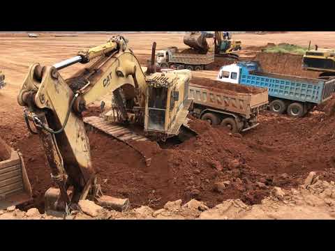 Caterpillar 245, Caterpillar 375 And Caterpillar 365C Excavators Loading Trucks