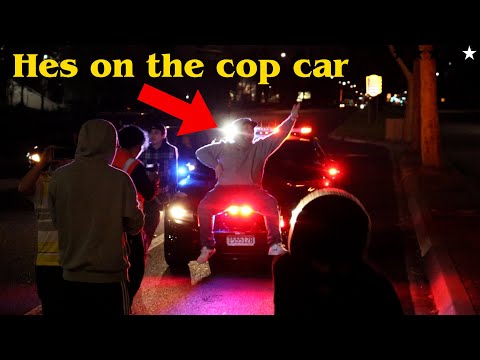 GUY SITS ON TOP OF THE COP CAR!! BLOCKERS FTW!