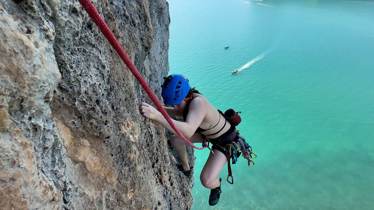 A tourist embarks on an exhilarating rock-climbing adventure.