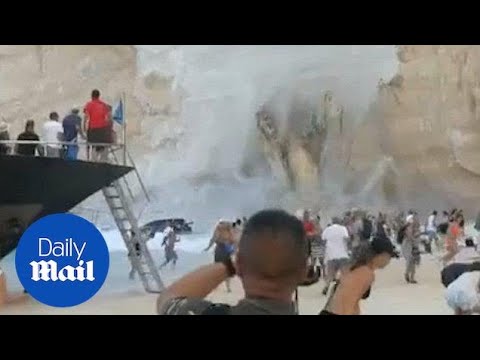 Screaming tourists run as cliff landslide causes mini tsunami