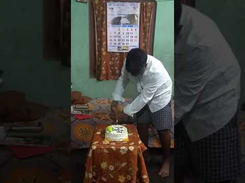Gaurab cutting birthday cake using prosthetic arms