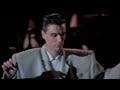 David Byrne dancing in a big suit