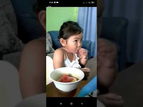 Baby girl eating her favorite fruit