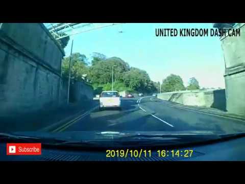 SILVER CAR DRIVER OVERTAKING CYCLIST OVER DOUBLE SOLID WHITE LINES