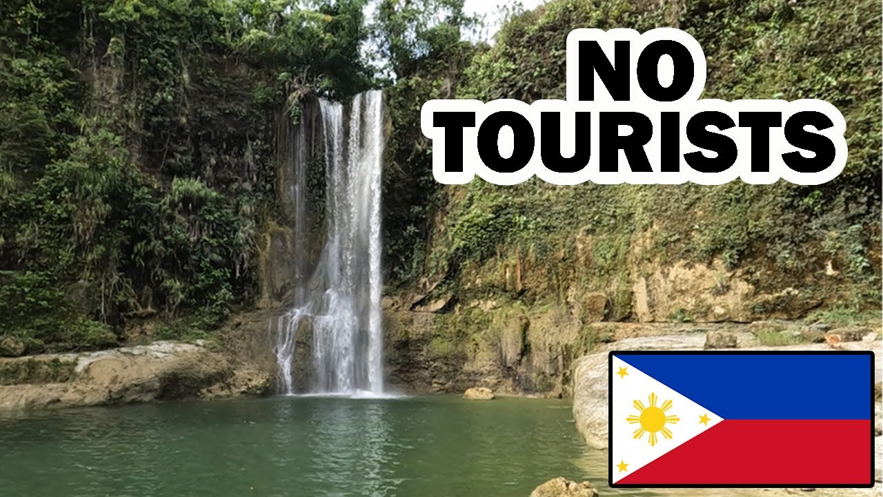 Travelers hike cascading Camugao Falls to in this video.