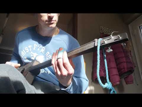 My 'Celestial slides' being used on a 3 string fretless acoustic cigar box guitar.