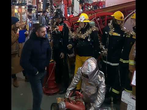 1970s Firemans Uniform With Yellow Cork Helmet Nomex Fire Tunic And The Iconic Yellow Waterproof Overtrousers mannequin-man performming as a Museum Dummy: The Essex Fire Museum added some christmas decorations to the historic firefighter uniform dispolay for Essex Fire Museum on 17/12/2023