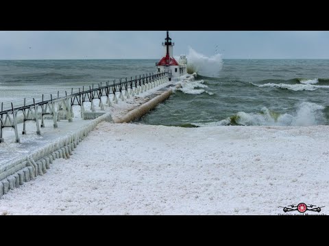 Ice-encrusted pier battered by waves in stunning drone video