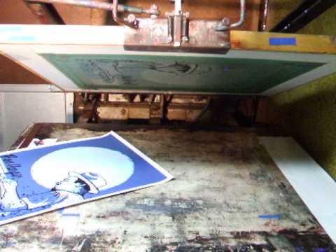 Vintage semi automatic printing press in action.