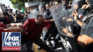 Anti-caravan protesters clash with police in Tijuana