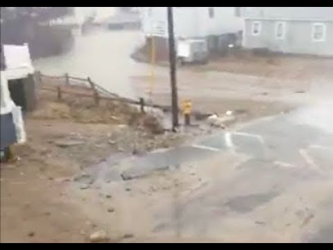 Waves plowing through neighborhoods in Scituate