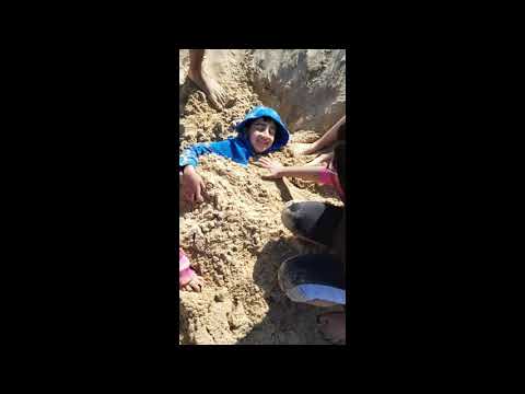 Enjoying in the beach/Lovely sunny weather/kids playing with sand/Nice day out