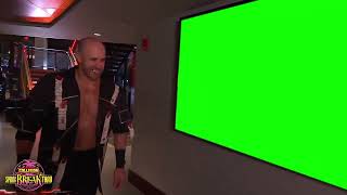 Claudio Castagnoli walks past a green screen