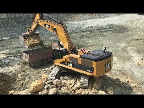 Caterpillar 385C Excavator Loading Caterpillar Dumper And Truck - Kivos Ate