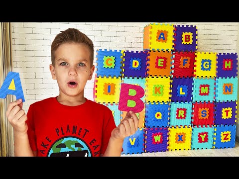 Mark looks for letters and opens boxes with surprises to learn the alphabet