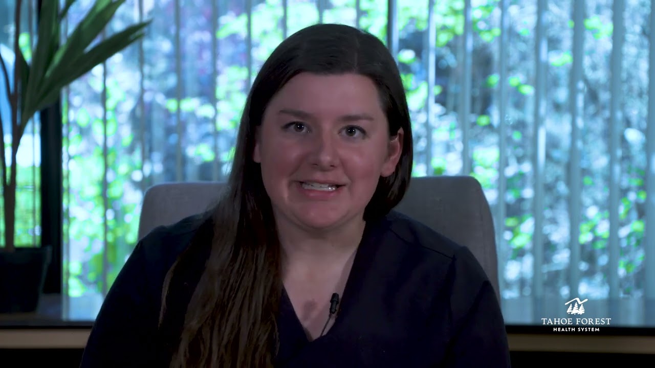 Kari Rezac, Sports Medicine Physician and Director of Sports Medicine, sitting in front of a window
