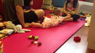 Baby Ashley is learning to crawl and big sister Natalie is so sweet with her
