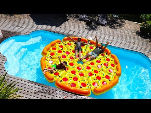 children play with a giant inflatable pizza in Swimming Pool Video