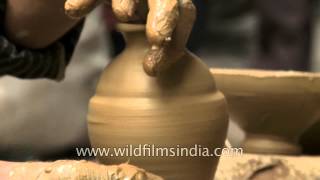 Spinning the wheel to mould clay into diyas for Diwali, Delhi