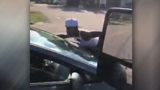 &#39;She&#39;s trying to kill me!&#39; Woman clings to car on busy road