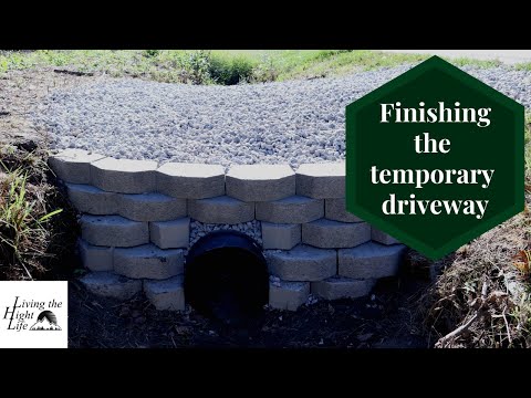 The temporary driveway is finished! Adding gravel, clearing brush, and mulching trees. We did it!