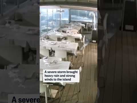 Video shows the moment a storm surge floods the dining room of an Italian seafront restaurant