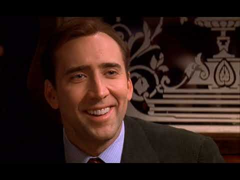 Trailer still: suburban driveway at dusk; pop ballad fades under Elfman’s strings