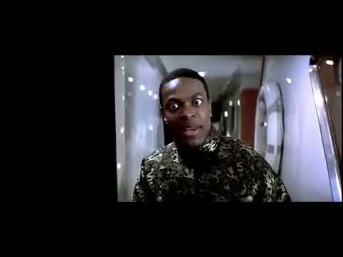 Rush Hour 2 trailer still — Carter and Lee stride through Hong Kong neon as a hip-hop beat snaps under Schifrin’s spy-jazz pulse