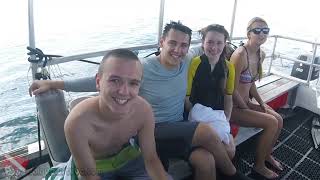 Two first-time SCUBA divers descending toward a reef at Horseshoe Reef in Honolulu.