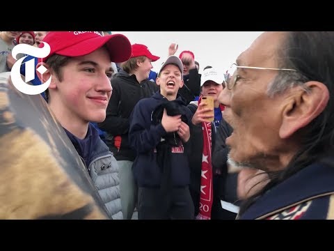 , title : 'A Video of Teenagers and a Native American Man Went Viral. Here’s What Happened. | NYT News'