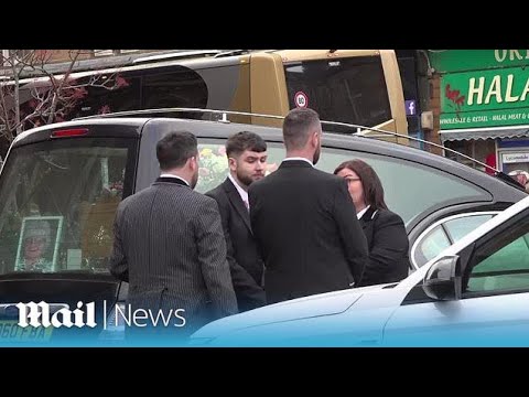 People clap as Janey Godley's coffin leaves funeral service