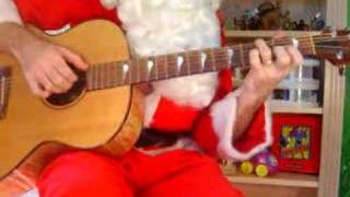 Santa plays God Rest Ye Merry Gentlemen on acoustic guitar
