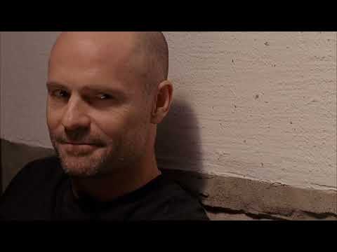 One Week official trailer still — motorcycle against prairie horizon, road-movie soundtrack in mind