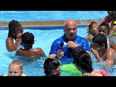 Fully clothed mayor gets 'pushed' into pool by city kids