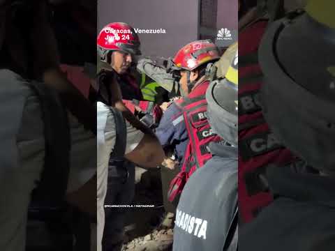 Firefighters give water to rescued dog in Caracas