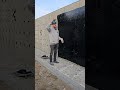 Luke explains the purpose of the black tar on a foundation wall. What should he explain next?