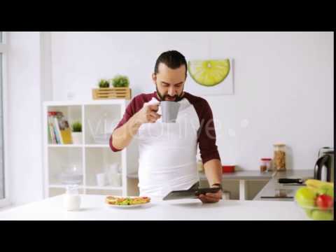 Man with Tablet Pc Eating Breakfast at Home 22 | Stock Footage - Videohive