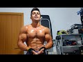 Young stud flexing huge shredded muscles after workout