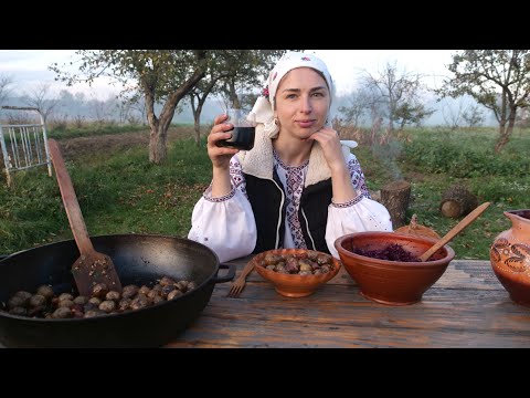 WOMAN LIVES in the village. Cooking POTATOES with BACON on fire. Making special Ukrainian drink