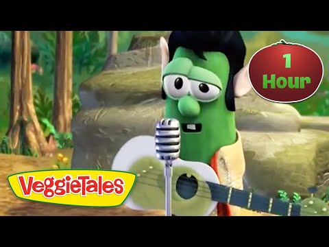 Green VeggieTales character (Larry the Cucumber) sings into a microphone while strumming a guitar; VeggieTales logo visible in the corner.