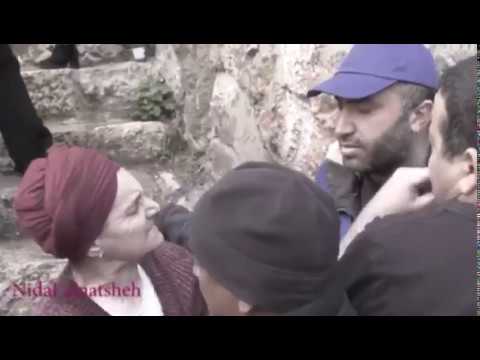 A Palestinian activist is slapped in the face by a settler in Hebron