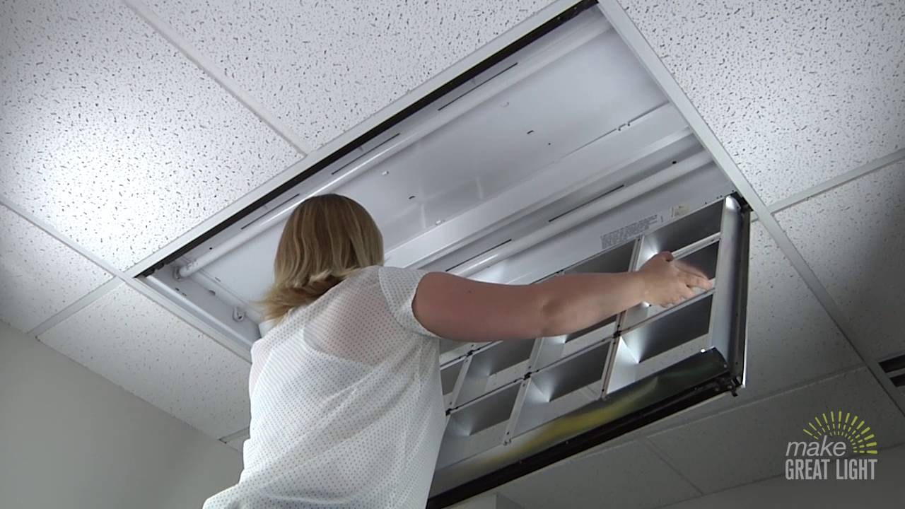Parabolic fluorescent fixture with NaturaLux filter being installed