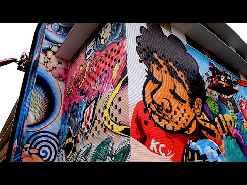 Plaza building tagged with graffiti from protests gets a mural with a message