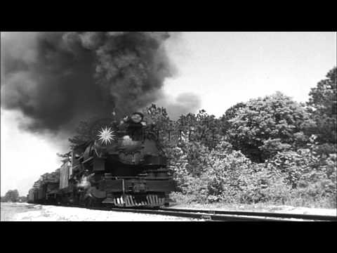 Moving freight train carries military equipment in United States. HD Stock Footage