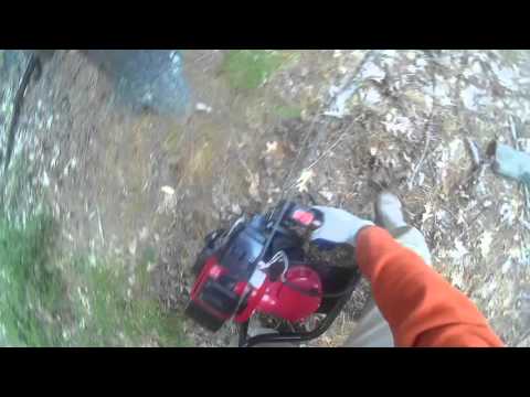 Harbor Freight 1.5 hp auger  drilling into dirt with rocks