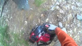 Harbor Freight 1.5 hp auger  drilling into dirt with rocks