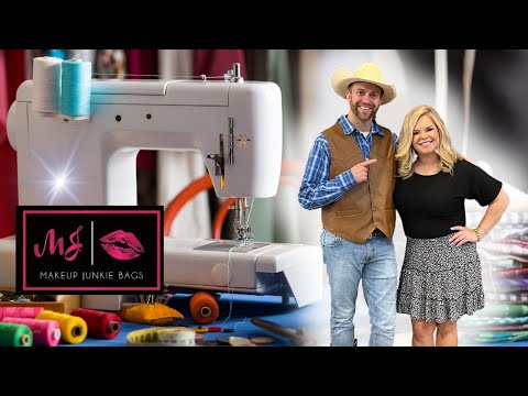 Sewing machine on a blue-worktable with colorful thread spools and fabric; logo reads 'Makeup Junkie Bags' as two hosts stand nearby, smiling.