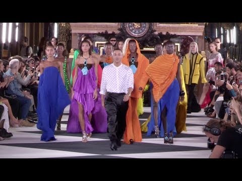 Models and designer on the runway for the Balmain Fashion Show in Paris
